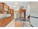 View of kitchen with granite island and wood cabinets at 741 Fairway Ridge Ct, Sun City Center, FL 33573