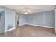 Open living room with wood-look floors and access to bathroom at 741 Fairway Ridge Ct, Sun City Center, FL 33573