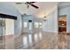 Open living and dining area with hardwood floors and access to patio at 741 Fairway Ridge Ct, Sun City Center, FL 33573