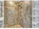 Large tiled walk-in shower with glass block feature wall at 741 Fairway Ridge Ct, Sun City Center, FL 33573