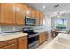 Kitchen with stainless steel appliances and wood cabinets at 8003 Limestone Ln # 15-103, Sarasota, FL 34233