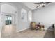 Open living room with tile floors, arched entryways, and access to a patio at 8003 Limestone Ln # 15-103, Sarasota, FL 34233