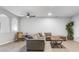 Spacious living room with sectional sofa, accent chair, and tiled floor at 8003 Limestone Ln # 15-103, Sarasota, FL 34233