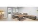 Open living room with sectional sofa, coffee table, and access to screened porch at 8003 Limestone Ln # 15-103, Sarasota, FL 34233