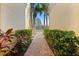 Brick walkway leads to the condo with lush green landscaping at 8003 Limestone Ln # 15-103, Sarasota, FL 34233