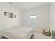 Bright bedroom with plush carpet and large window at 9011 Waxwing Way, Parrish, FL 34219