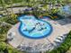 Aerial view of a community splash pad area with shaded seating and kid-friendly water features at 9011 Waxwing Way, Parrish, FL 34219