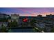 Aerial view of the property at sunset with tennis courts nearby at 1130 W Peppertree Ln # 118, Sarasota, FL 34242