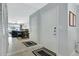 Bright condo entry with a large mirror reflecting the living and dining areas at 1130 W Peppertree Ln # 118, Sarasota, FL 34242