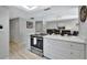 Modern kitchen with white cabinets and stainless steel appliances at 1130 W Peppertree Ln # 118, Sarasota, FL 34242