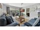 Comfortable living room with blue sofas, a TV, and access to a balcony at 1130 W Peppertree Ln # 118, Sarasota, FL 34242