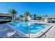 Inviting community pool with lounge chairs and umbrellas at 1130 W Peppertree Ln # 118, Sarasota, FL 34242