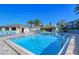 Community pool area with plenty of lounge chairs at 1130 W Peppertree Ln # 118, Sarasota, FL 34242