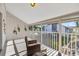Relaxing screened porch with wicker chairs, offering peaceful views at 1130 W Peppertree Ln # 118, Sarasota, FL 34242