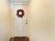 Condo entryway with wreath and hardwood floors at 147 Pinehurst Dr # 147, Bradenton, FL 34210