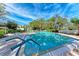 Inviting community pool with lounge chairs and surrounding foliage at 147 Pinehurst Dr # 147, Bradenton, FL 34210