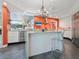 Modern kitchen with granite island, stainless steel appliances, and coral-colored walls at 1701 Starling Dr, Sarasota, FL 34231