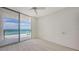 Cozy bedroom featuring sliding glass doors to a private balcony with ocean views at 1800 Benjamin Franklin Dr # A405, Sarasota, FL 34236