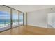 Bright living space with wood floors and floor-to-ceiling windows with ocean views at 1800 Benjamin Franklin Dr # A405, Sarasota, FL 34236