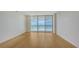 Bright, open living room featuring wood floors and sliding glass doors with ocean view at 1800 Benjamin Franklin Dr # A405, Sarasota, FL 34236