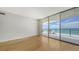 Light-filled room with wood floors and expansive windows offering ocean and beach views at 1800 Benjamin Franklin Dr # A405, Sarasota, FL 34236