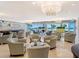 Refined lobby and seating area with elegant chandelier lighting and stunning beach views at 1800 Benjamin Franklin Dr # A405, Sarasota, FL 34236