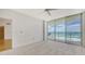 Cozy bedroom with plush carpet, a large window to the ocean, and bright natural light at 1800 Benjamin Franklin Dr # A405, Sarasota, FL 34236
