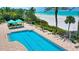 Aerial view of a stunning pool with lounge chairs near a white sand beach at 1800 Benjamin Franklin Dr # A405, Sarasota, FL 34236