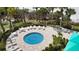 Relaxing circular pool area surrounded by tropical landscaping and comfortable seating at 1800 Benjamin Franklin Dr # A405, Sarasota, FL 34236
