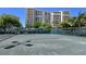 Well-maintained tennis court set against the backdrop of a luxury high-rise building at 1800 Benjamin Franklin Dr # A405, Sarasota, FL 34236
