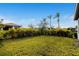 Spacious grassy backyard with lush landscaping and privacy hedges at 1901 6Th E St, Palmetto, FL 34221