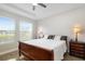Main bedroom with large windows and wooden sleigh bed at 1901 6Th E St, Palmetto, FL 34221