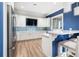 Modern community kitchen with white cabinets and herringbone backsplash at 1901 6Th E St, Palmetto, FL 34221