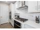 Bright kitchen with white cabinets, stainless steel appliances, and gas cooktop at 1901 6Th E St, Palmetto, FL 34221