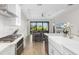 Open kitchen design with island, stainless steel appliances, and view of living room at 1901 6Th E St, Palmetto, FL 34221