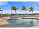 Community pool with lounge chairs and palm trees at 1901 6Th E St, Palmetto, FL 34221