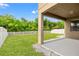 Private backyard with grassy lawn and covered patio at 1964 Hawks View Dr, Ruskin, FL 33570