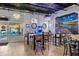 Bright bar interior with tables, chairs, and a mural at 1964 Hawks View Dr, Ruskin, FL 33570