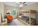 Cozy bedroom with a bunk bed and a comfortable sitting area at 1964 Hawks View Dr, Ruskin, FL 33570
