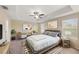 Spacious bedroom with a large bed, two nightstands and a ceiling fan at 1964 Hawks View Dr, Ruskin, FL 33570