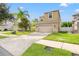 Two-story house with beige exterior, two-car garage, and manicured lawn at 1964 Hawks View Dr, Ruskin, FL 33570