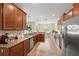 Modern kitchen with granite countertops, stainless steel appliances, and wood cabinets at 1964 Hawks View Dr, Ruskin, FL 33570