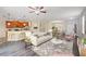 Open living room with hardwood floors, neutral color scheme, and access to kitchen at 1964 Hawks View Dr, Ruskin, FL 33570