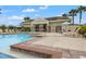 Community pool with lounge chairs and a nearby building at 1964 Hawks View Dr, Ruskin, FL 33570