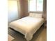 Bright bedroom with a comfortable queen-sized bed, neutral-toned walls, and a sunlit window at 2271 Sandlewood Dr, Venice, FL 34293