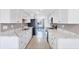 Galley kitchen featuring white cabinets, granite countertops, and stainless steel appliances at 2271 Sandlewood Dr, Venice, FL 34293