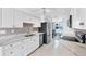 Kitchen with sleek white cabinetry, granite countertops and modern stainless-steel appliances at 2271 Sandlewood Dr, Venice, FL 34293