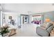 Spacious living room with terrazzo floors flows into a sunroom with lake views at 2271 Sandlewood Dr, Venice, FL 34293