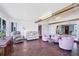 Spacious sunroom with warm stone floors, beam ceiling, and lots of natural light at 2271 Sandlewood Dr, Venice, FL 34293