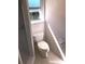 Clean and functional bathroom with a standard toilet, window and tile flooring at 2271 Sandlewood Dr, Venice, FL 34293